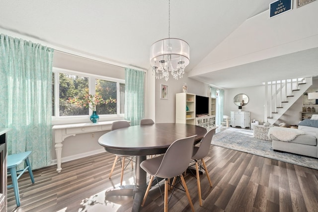 dining room featuring lofted ceiling, dark wood-type flooring, and a chandelier