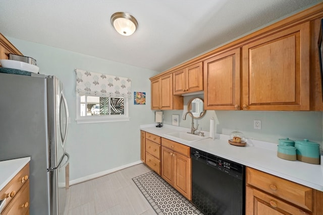 kitchen with dishwasher, stainless steel fridge, and sink