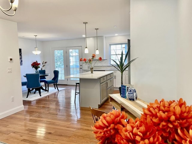 215 High St Unit 18, Taunton, MA 02780 - kitchen with a wealth of natural light, light wood-style floors, a breakfast bar, and light countertops