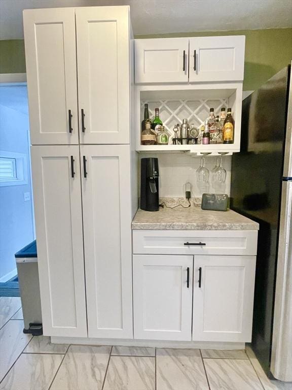 bar featuring marble finish floor and a bar