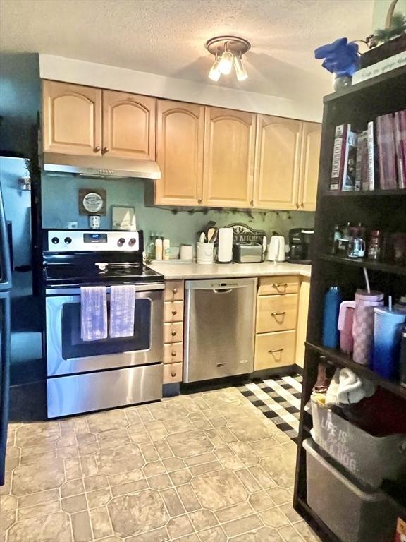 15 Old County Rd, Holland, MA 01521 - kitchen featuring light brown cabinets, light countertops, a textured ceiling, under cabinet range hood, and appliances with stainless steel finishes