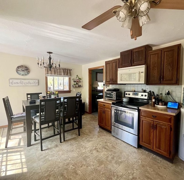 15 Old County Rd, Holland, MA 01521 - kitchen featuring tasteful backsplash, stainless steel range with electric stovetop, light countertops, white microwave, and ceiling fan with notable chandelier