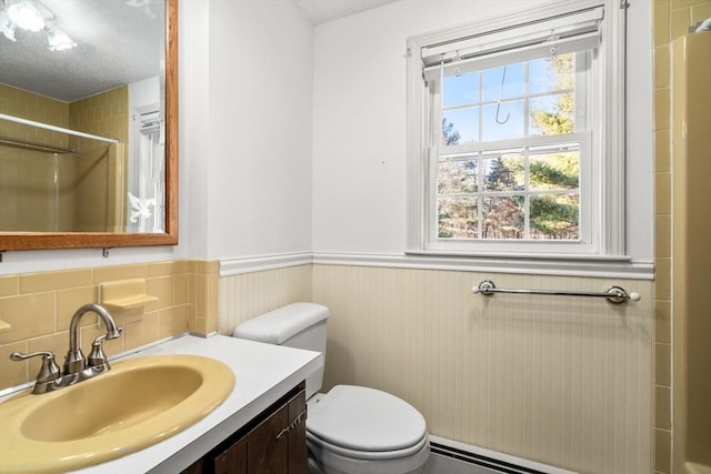 209 Pleasant, Millis, MA 02054 - bathroom featuring a shower, a wainscoted wall, toilet, vanity, and a baseboard radiator