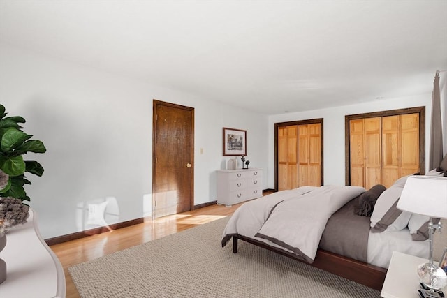 209 Pleasant, Millis, MA 02054 - bedroom with light wood-style floors, two closets, and baseboards