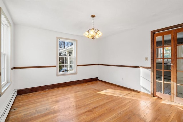 209 Pleasant, Millis, MA 02054 - empty room with a baseboard radiator, a chandelier, light wood finished floors, and baseboards