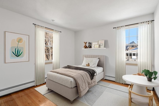 209 Pleasant, Millis, MA 02054 - bedroom with a baseboard heating unit and light wood-style flooring