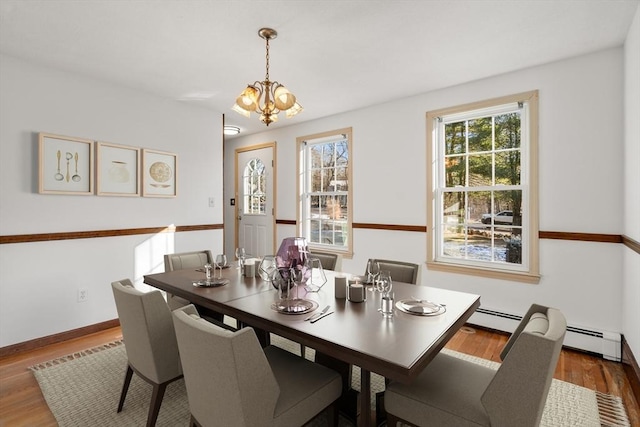 209 Pleasant, Millis, MA 02054 - dining space featuring wood finished floors, a chandelier, and a baseboard radiator