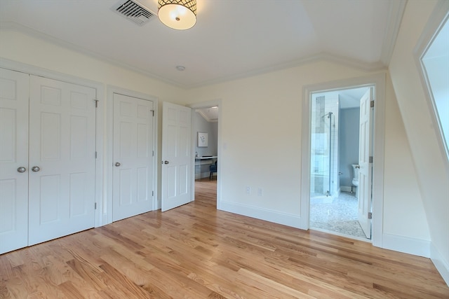 unfurnished bedroom with connected bathroom, light wood-type flooring, and ornamental molding