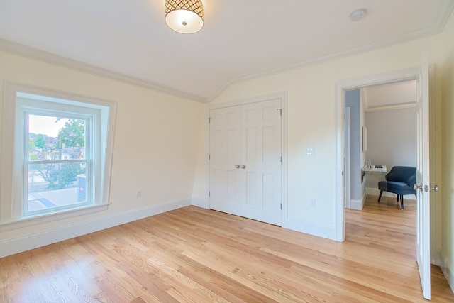 unfurnished bedroom with a closet, light wood-type flooring, and ornamental molding