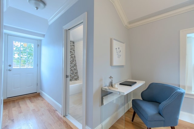 office space with crown molding and light wood-type flooring