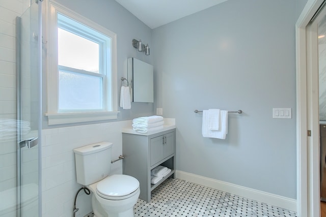 bathroom featuring vanity, walk in shower, toilet, and tile patterned floors