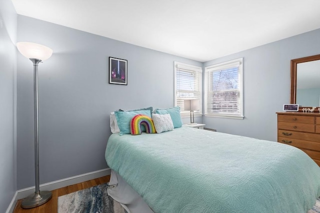 bedroom featuring baseboards and wood finished floors