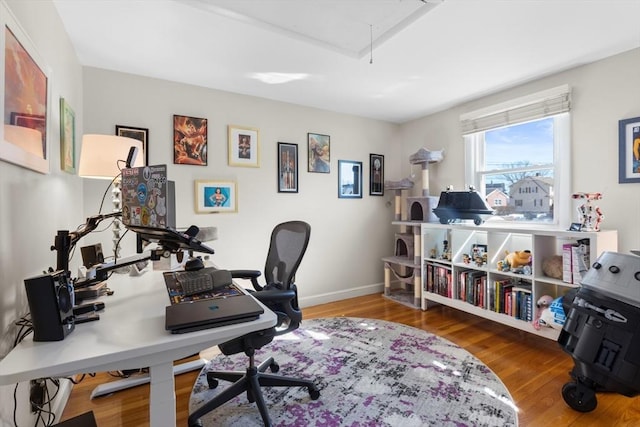 home office featuring attic access, wood finished floors, and baseboards