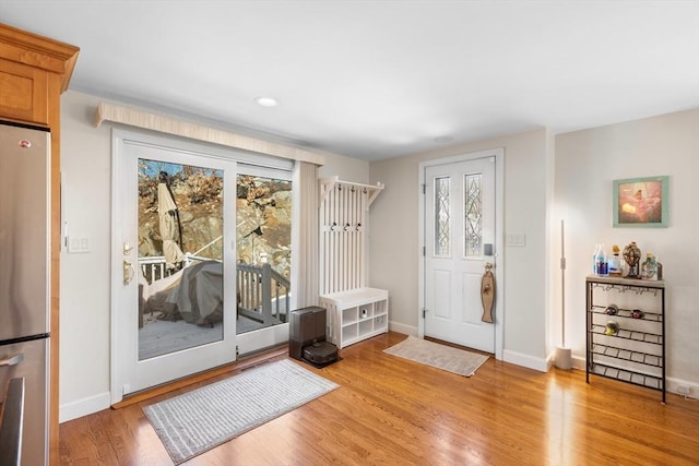 foyer entrance with baseboards and light wood finished floors