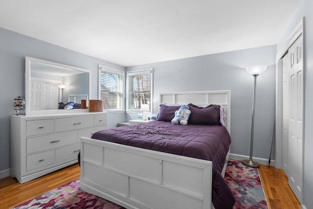 bedroom with light wood-style floors and baseboards