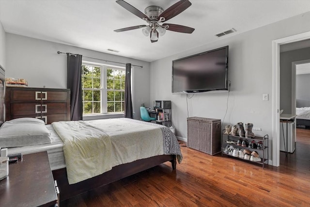 bedroom featuring visible vents, a ceiling fan, and wood finished floors