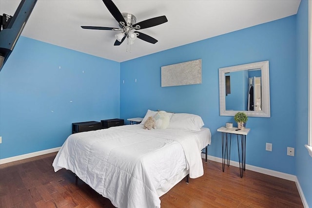 bedroom with baseboards, ceiling fan, and wood finished floors