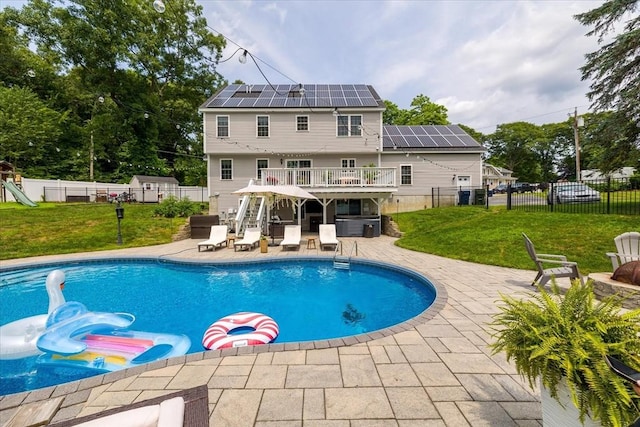 view of swimming pool featuring a wooden deck, a patio area, a fenced in pool, a fenced backyard, and a yard