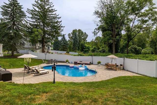 view of swimming pool with a fenced in pool, a fenced backyard, a patio area, and a yard