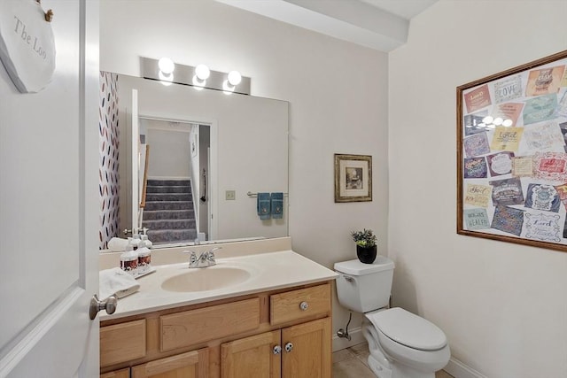 bathroom featuring toilet and vanity