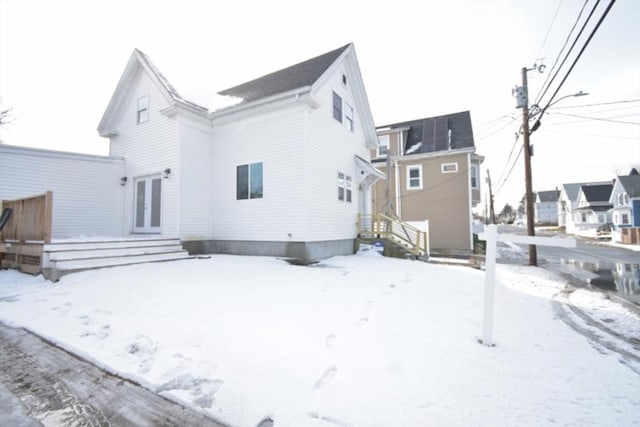 snow covered property featuring french doors