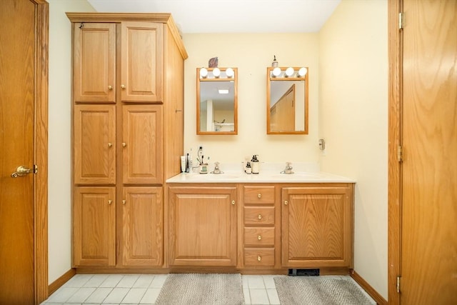 1441 Stafford Rd, Fall River, MA 02721 - bathroom with double vanity, tile patterned flooring, baseboards, and a closet
