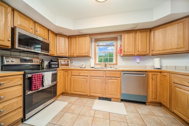 1441 Stafford Rd, Fall River, MA 02721 - kitchen with appliances with stainless steel finishes, a sink, light tile patterned flooring, and light countertops