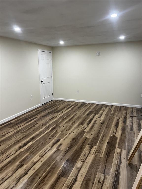 spare room with dark hardwood / wood-style floors