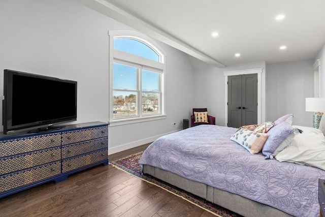 bedroom with baseboards, vaulted ceiling, recessed lighting, wood finished floors, and a closet