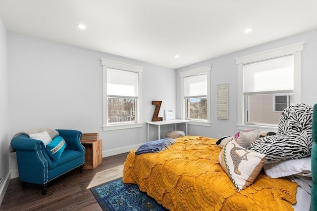 bedroom featuring recessed lighting, baseboards, multiple windows, and wood finished floors