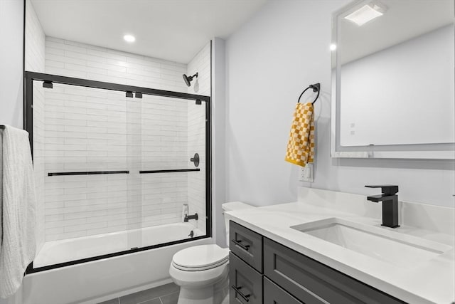 bathroom with toilet, recessed lighting, shower / bath combination with glass door, tile patterned flooring, and vanity