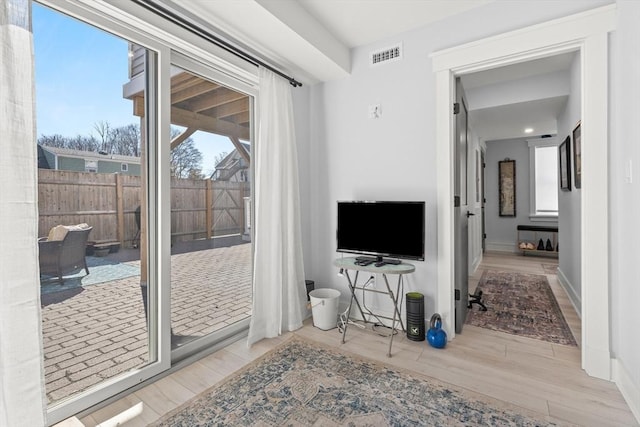 interior space featuring wood finished floors, visible vents, and baseboards