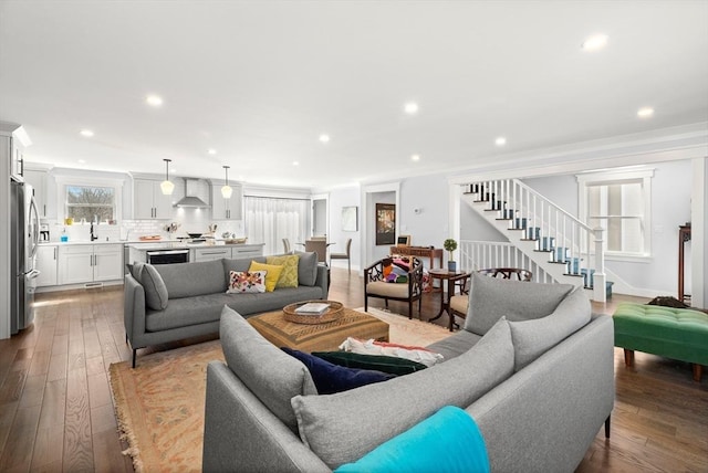 living room with hardwood / wood-style floors, stairway, and recessed lighting