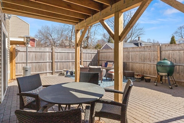 view of patio featuring outdoor dining area, an outdoor hangout area, a grill, and a fenced backyard