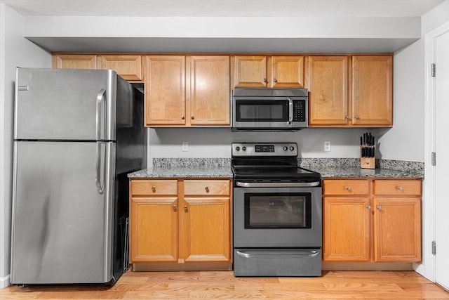 18 Hitching Post Ln Unit 18, Northborough, MA 01532 - kitchen with appliances with stainless steel finishes, light wood-style flooring, and stone counters