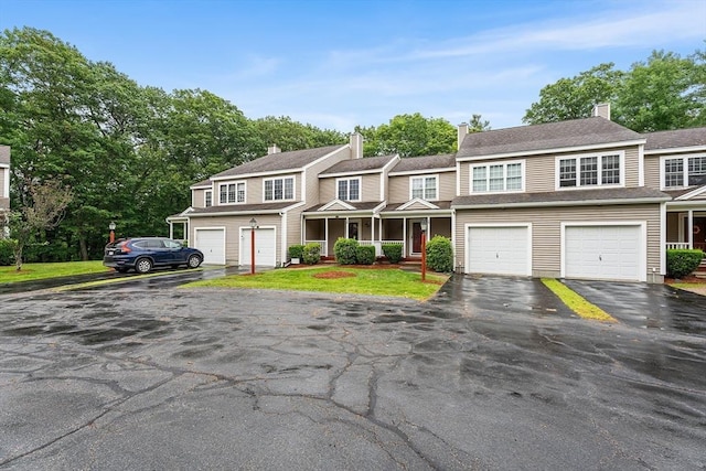 18 Hitching Post Ln Unit 18, Northborough, MA 01532 - townhome / multi-family property with driveway, an attached garage, covered porch, and a chimney