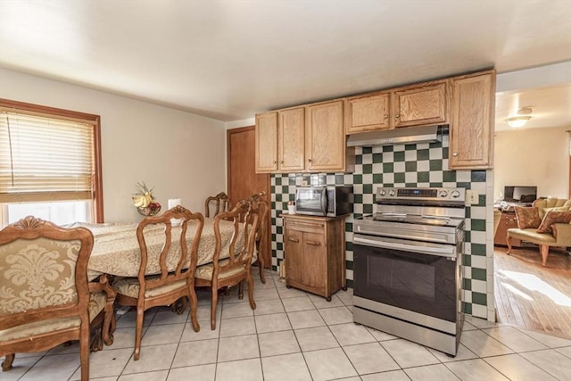 43 Huntington St, Brockton, MA 02301 - kitchen featuring appliances with stainless steel finishes, under cabinet range hood, light tile patterned floors, and backsplash