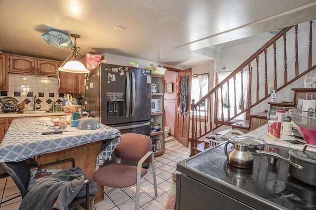 43 Huntington St, Brockton, MA 02301 - kitchen featuring electric range, tasteful backsplash, light tile patterned flooring, tile countertops, and decorative light fixtures