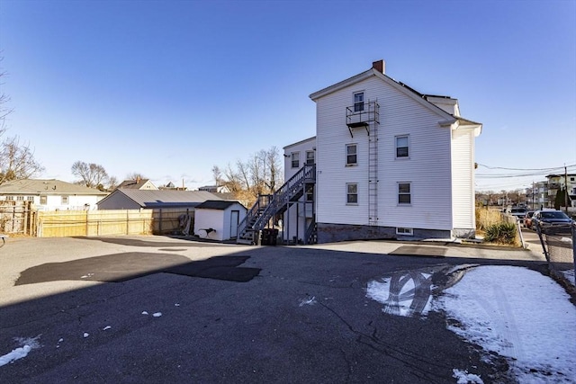 43 Huntington St, Brockton, MA 02301 - rear view of house featuring stairway and a chimney