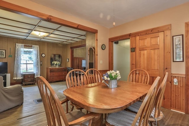 32 Carter St, Hudson, MA 01749 - dining space with wooden walls, wood finished floors, arched walkways, and wainscoting