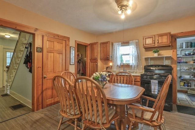 32 Carter St, Hudson, MA 01749 - dining space with dark wood-style flooring and stairway