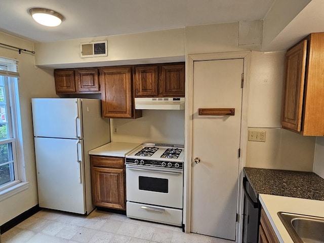 403 Windsor Dr Unit 0, Framingham, MA 01701 - kitchen with white appliances, under cabinet range hood, and brown cabinetry