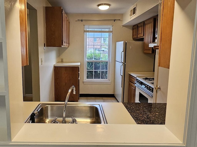 403 Windsor Dr Unit 0, Framingham, MA 01701 - kitchen with white appliances, brown cabinets, and ventilation hood