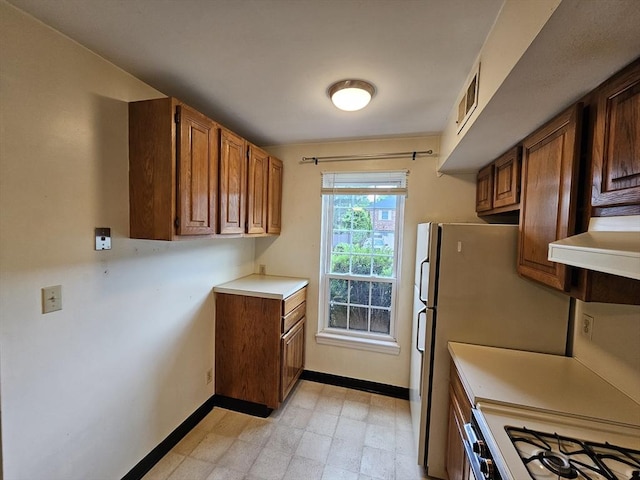 403 Windsor Dr Unit 0, Framingham, MA 01701 - kitchen featuring gas range gas stove, light countertops, light flooring, and brown cabinets