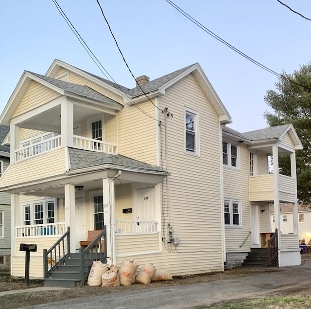 view of front of property with a balcony and covered porch