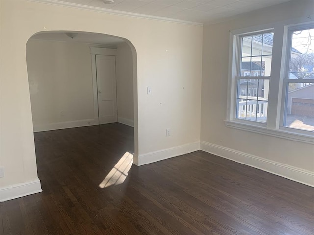 spare room featuring dark hardwood / wood-style flooring and ornamental molding