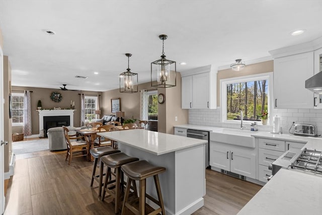 kitchen featuring visible vents, a sink, a wealth of natural light, and open floor plan