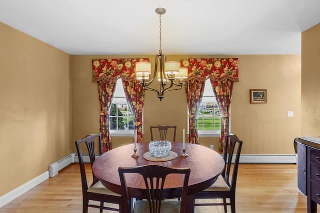 dining space featuring a baseboard radiator, a notable chandelier, and a healthy amount of sunlight