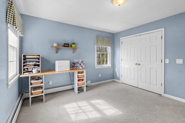 office area featuring carpet floors, baseboards, and a baseboard radiator