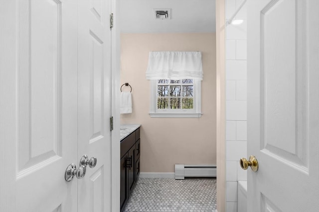 bathroom with baseboard heating, vanity, tile patterned floors, baseboards, and visible vents